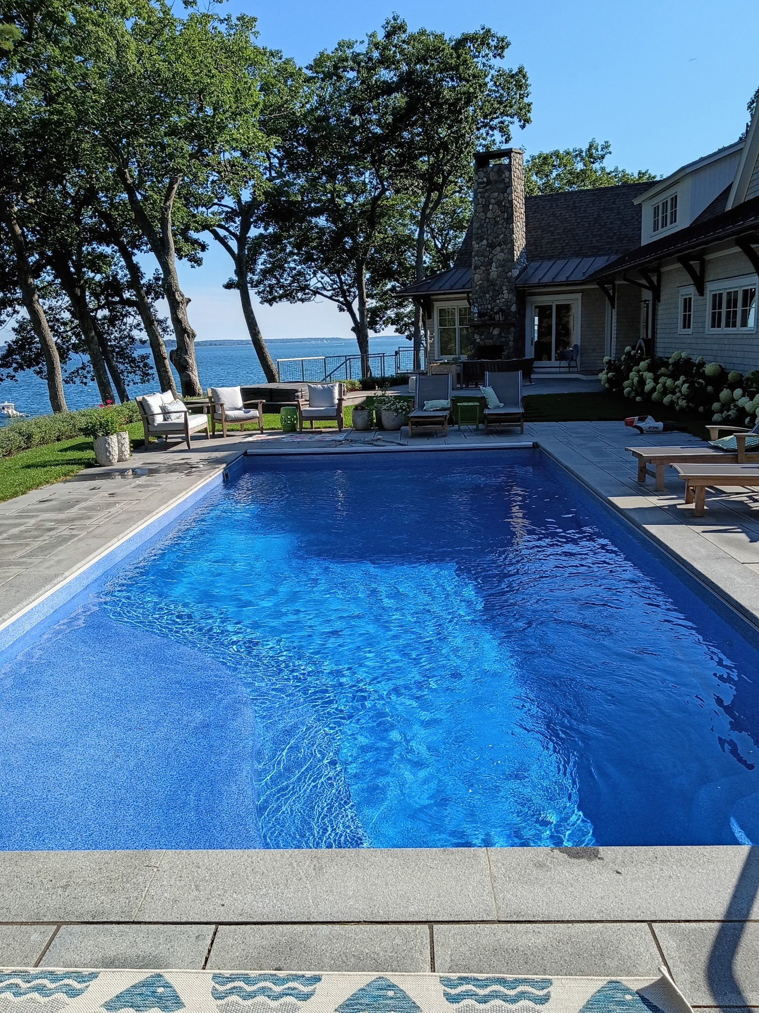 Clear blue water beside a home and patio